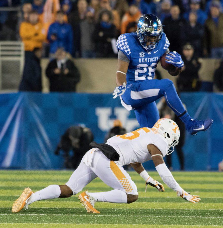 Kentucky Wildcats running back Benny Snell Jr. hurdles a Tennessee Volunteers defender during the game at Kroger Field in Lexington, Ky. on Saturday, October 28, 2017. Photo by Josh Mott | Staff.