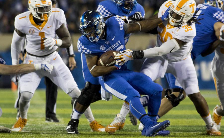 Kentucky Wildcats running back Benny Snell Jr. tries to spin away from Tennessee Volunteers defensive lineman Kendal Vickers during the game at Kroger Field in Lexington, Ky. on Saturday, October 28, 2017. Photo by Josh Mott | Staff.