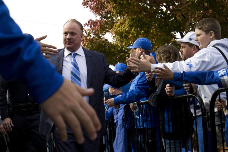Head coach Mark Stoops of the Kentucky Wildcats high fives UK fans during the Cat Walk prior to the game against Vanderbilt University on Saturday, November 11, 2017 in Nashville, Tennessee. Photo by Arden Barnes | Staff