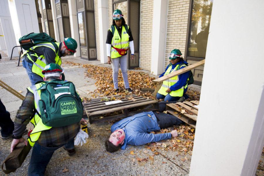 C-CERT members react to a victim trapped under debris during the Campus Community Emergency Response Team exercise near Kirwan IV on south campus on Thursday, November 9, 2017 in Lexington, Kentucky. The UK Police Department’s Division of Crisis Management & Preparedness offers the C-Cert training for UK faculty and staff. Photo by Arden Barnes | Staff