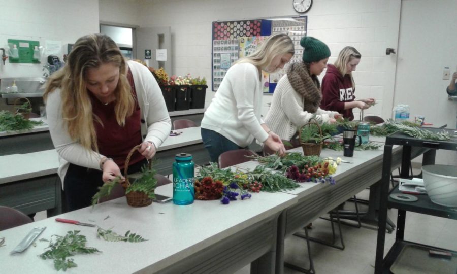Members of the UK Horticulture Club assemble fall baskets in November 2017.