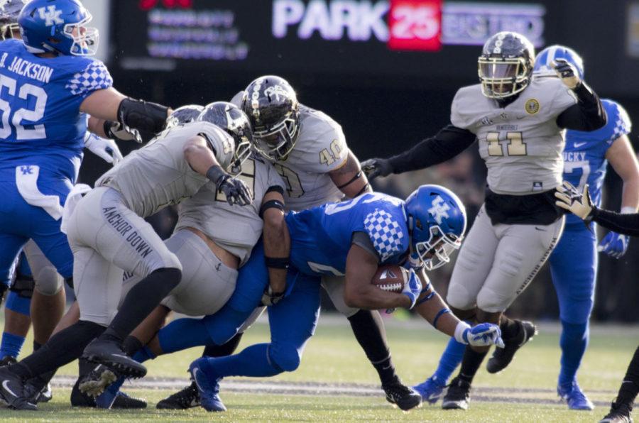 Benny Snell Jr. #26 of the Kentucky Wildcats is tackled to the ground during the game against Vanderbilt University on Saturday, November 11, 2017 in Nashville, Tennessee. Kentucky won 44 to 21. Photo by Arden Barnes | Staff
