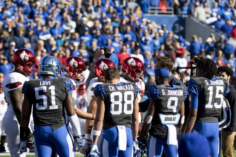 Kentucky captains linebacker Courtney Love (51), wide receiver Charles Walker (88), wide receiver Garrett Johnson (9), and quarterback Stephen Johnson (15) line up for the coin toss during the Governors Cup game against Louisville at Kroger Field on Saturday, November 25, 2017 in Lexington, Kentucky. Louisville won 44-17. Photo by Arden Barnes | Staff
