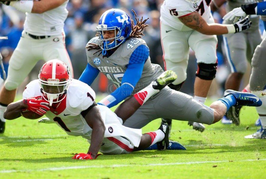 Linebacker Josh Forrest (45) of the Kentucky Wildcats tackles running back Sony Michel during the first half of the game against the University of Georgia Bulldogs at Commonwealth Stadium on Saturday, November 8, 2014 in Lexington, Ky. Kentucky trails Georgia 35-24. Photo by Michael Reaves