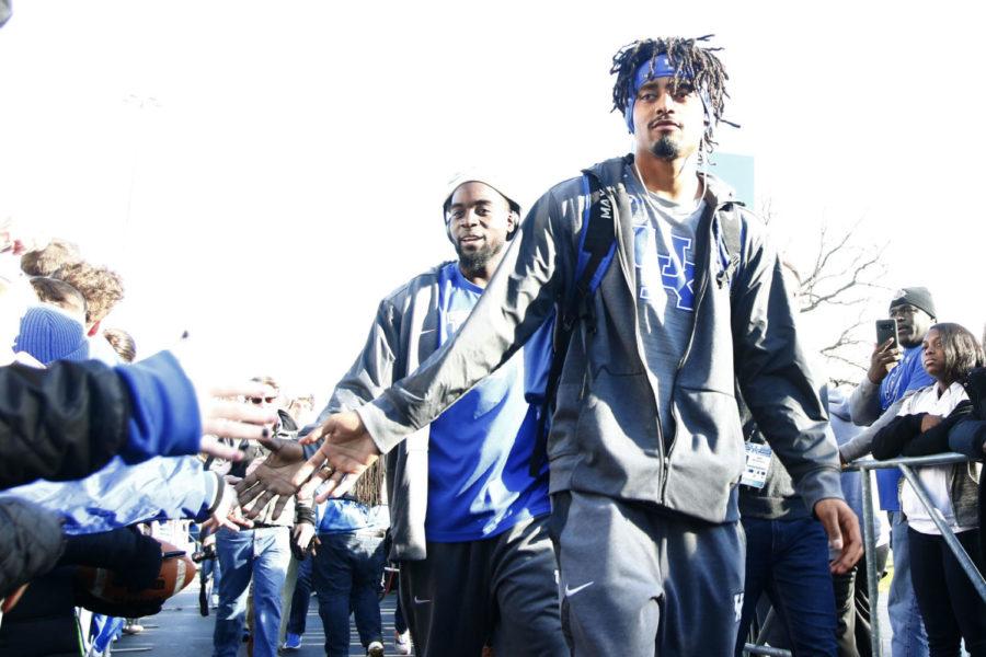 Senior quarterback Stephen Johnson high fives fans during the Catwalk prior to the senior day game against Louisville on Saturday, November 25, 2017 in Lexington, Ky. Louisville won the game 44-17.