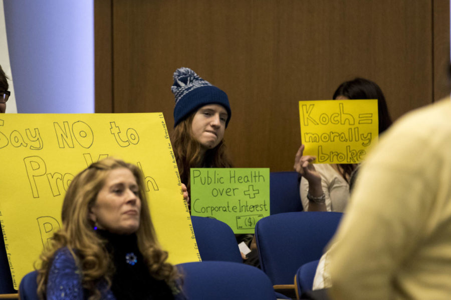 Graduate students held signs up in protest of provost candidate David Blackwell while he spoke to students, faculty, and staff in Kincaid Auditorium on Friday, December 8, 2017 in Lexington, Kentucky. Photo by Arden Barnes | Staff