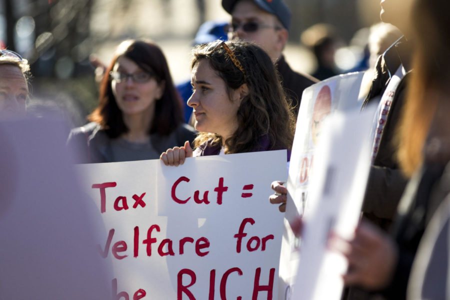 Rosie Davila gathered with other Lexingtonians at Triangle Park in downtown Lexington, Kentucky to protest the Tax Cuts and Jobs Act that was passed the morning of Saturday, December 2, 2017. Photo by Arden Barnes | Staff