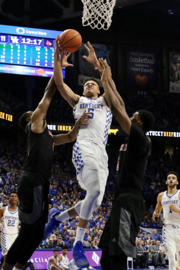 Freshman forward Kevin Knox is fouled on the way up for a layup during the game against Louisville on Friday, December 29, 2017 in Lexington, Ky. Kentucky won the game 90-61. Photo by Hunter Mitchell.