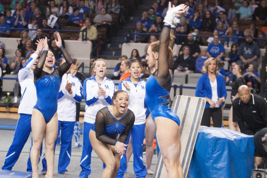 The UK gymnastics team celebrates after an uneven bar routine during the meet against the Florida Gators on Friday, March 4, 2016 in Lexington, Ky. Photo by Hunter Mitchell | Staff