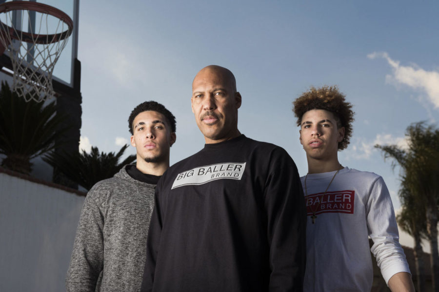 LaVar Ball, center, with his sons and Chino Hill High School basketball stars, LiAngelo, left, and LaMelo, right, on Feb. 22, 2017 at their home in Chino Hills, Calif. The family wears the Big Baller Brand line of clothing that LaVar started. (Leonard Ortiz/Orange County Register/TNS)