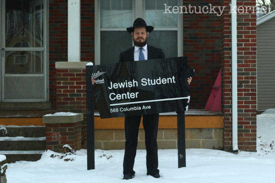 Rabbi Shlomo Litvin of the Chabad of the Bluegrass holds the broken Jewish Student Center sign in front of the posts the sign was previously mounted on Wednesday, January 17, 2018 in Lexington, Kentucky. Photo by Arden Barnes | Staff