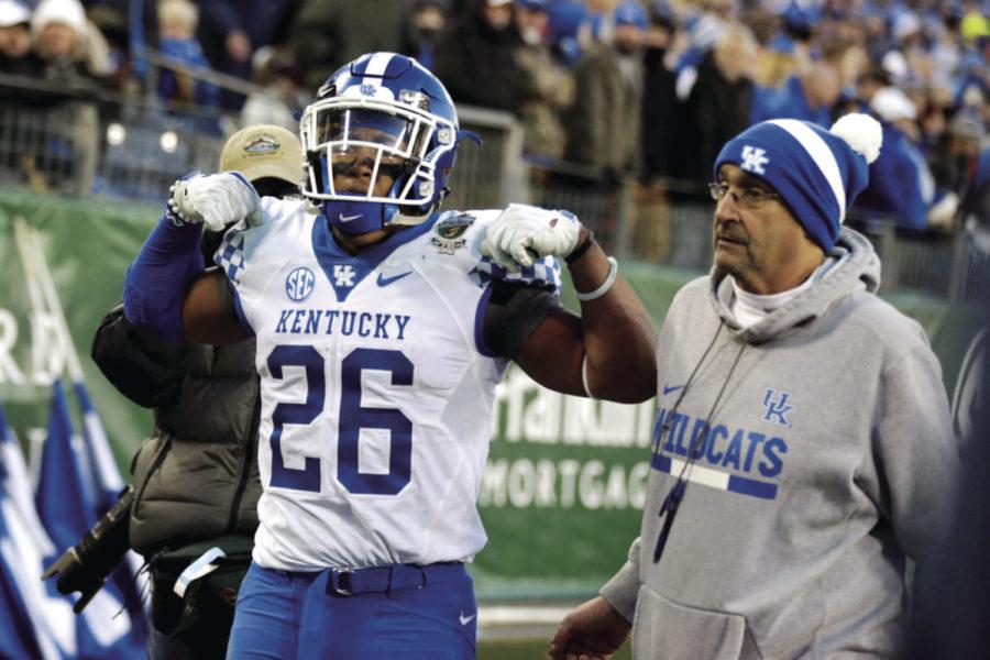 Kentucky Wildcats running back Benny Snell Jr. is escorted to the locker room after being ejected from the game during the Music City Bowl game against Northwestern on Friday, December 29, 2017 in Nashville, Tennessee. Kentucky was defeated 24-23. Photo by Arden Barnes | Staff