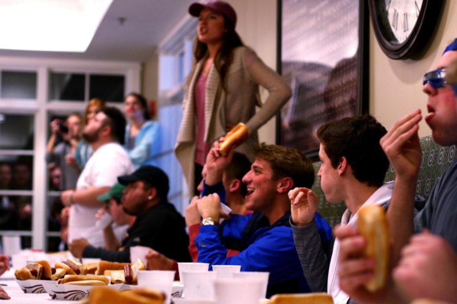 Hot dog-eating contestants stuff down their final dogs as time expired at the Alpha Phi House on Wednesday, Feb. 14, 2018. Photo by Rick Childress | Staff