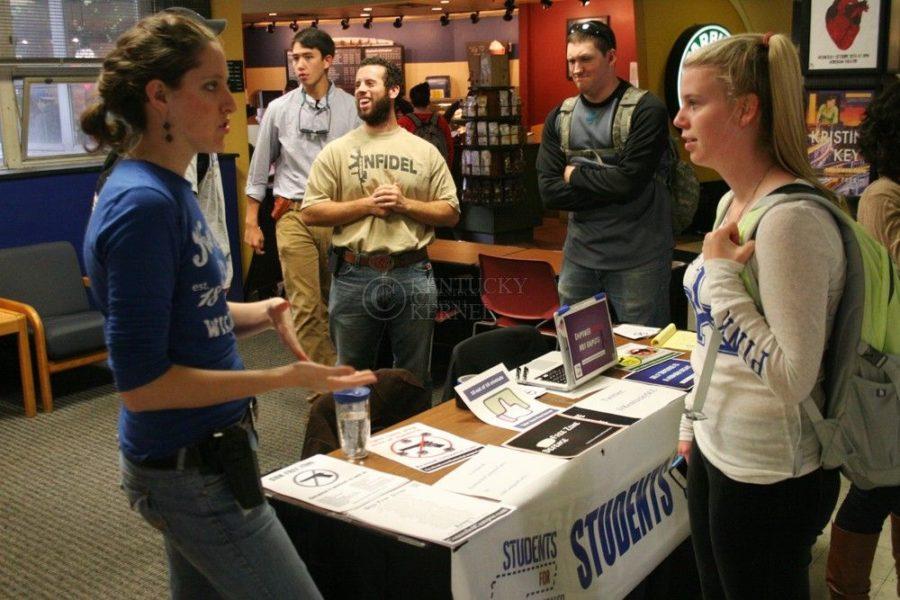 Diplomacy grad student Cassidy Henry talks with a student about her views on UKs concealed carry laws in Lexington, Ky., on Tuesday, October 29, 2013. Henry is the clubs secretary. Photo by Adam Pennavaria