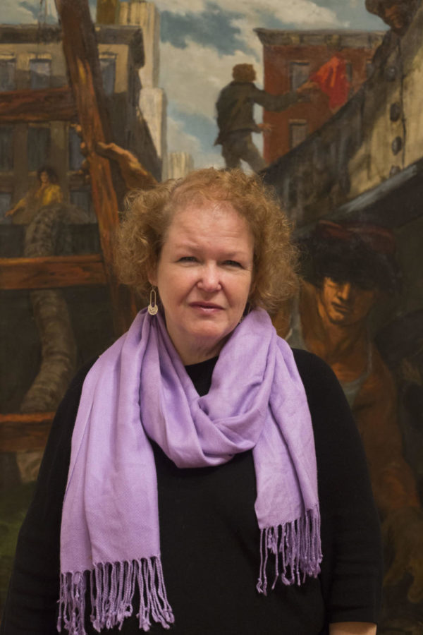Janie Welker, curator of the UK Art Museum, poses with Edward Melcarths painting Excavation. UK Art Museums Edward Melcarth: Points of View is on display until April 8. 