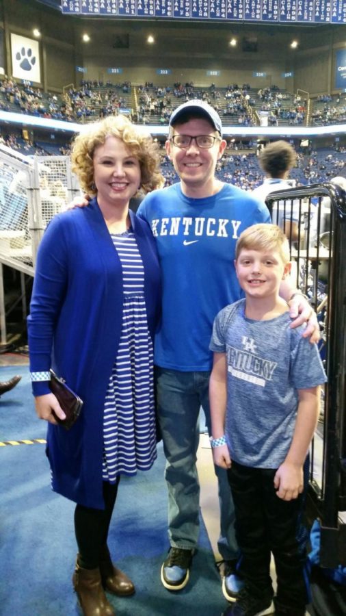 UK alumnus Jason Darnall, center, with his wife, Jenny, left, and nephew Maxx, right, at a UK basketball game. Darnall has completed marathons on all continents. 