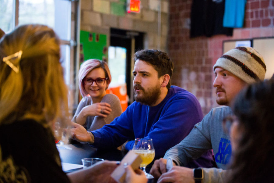 A group of friends discuss their answer to a question during trivia night at Ethereal Brewing on Tuesday, March 20, 2018 in Lexington, Kentucky. Photo by Jordan Prather | Staff
