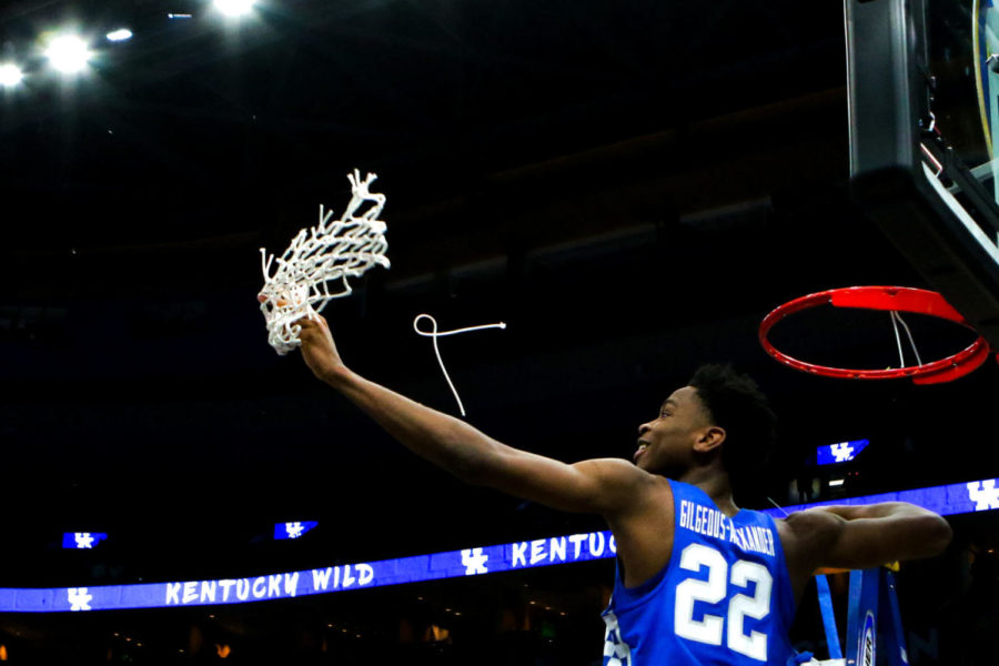 Kentucky freshman guard Shai Gilgeous-Alexander throws the net to his teammates in celebration after the game against Tennessee in the SEC tournament championship on Sunday, March 11, 2018, in St. Louis, Missouri. Kentucky defeated Tennessee 77-72. Photo by Arden Barnes | Staff