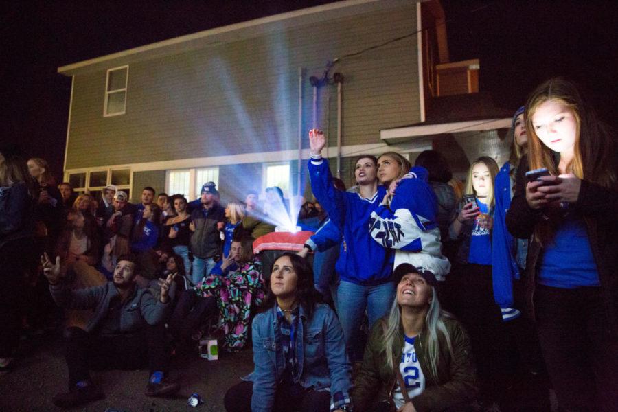 A crowd of students watch the Kentucky vs. Kansas State Sweet-Sixteen game as it is projected on the side of a State Street house on Thursday, March 22, 2018 in Lexington, Kentucky. Photo by Jordan Prather | Staff