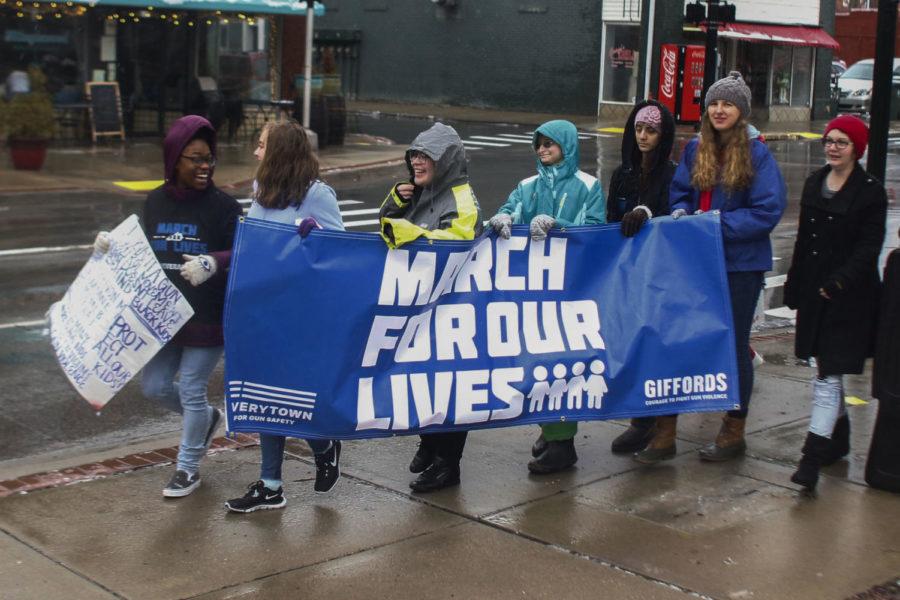 High schoolers leading the march down Short Street hurry to get the front of the crowd during the March For Our Lives Lexington that was held in concert with nationwide gun violence protests on March 24, 2018. Photo by Rick Childress | Staff