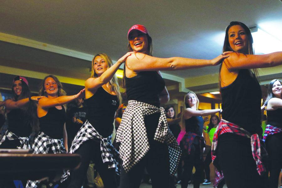 Chi Omega sisters rehearse their “Decades” Greek Sing routine on Wednesday night. The women will donate proceeds from ticket sales at Greek Sing to the Make-A-Wish Foundation. Greek Sing raised nearly $200,000 last year and granted wishes for 32 children.