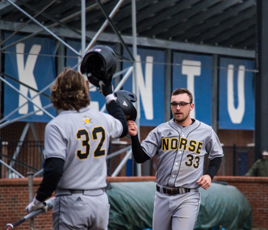 NKU #33 celebrates with a teammate after a home run on Wednesday, March 7, 2018 in Lexington, Ky. Kentucky was defeated 8 - 6. Photo by Edward Justice | Staff