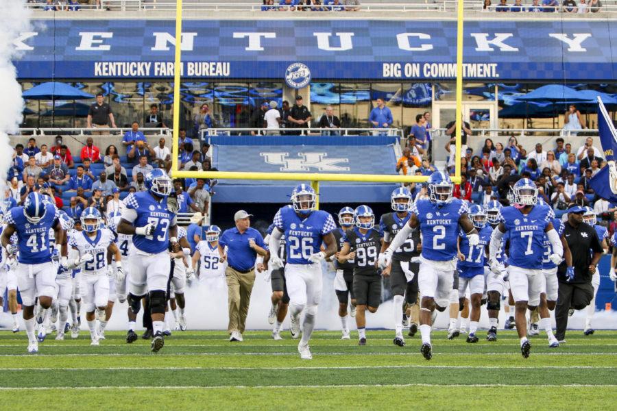 The Kentucky Wildcats take the field prior to the blue white spring game at Commonwealth Stadium on Friday, April 14, 2017 in Lexington, KY. Photo by Addison Coffey | Staff.