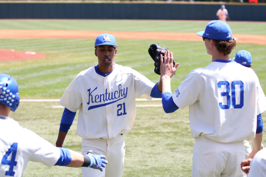 Junior Justin Lewis high fives his teammates on his way back to the dugout during the game against Florida on Saturday, April 21, 2018 in Lexington, Ky. Kentucky won 3-1. Photo by Chase Phillips | Staff