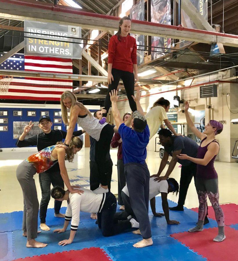 Circus and philosophy students practice making a human tower.