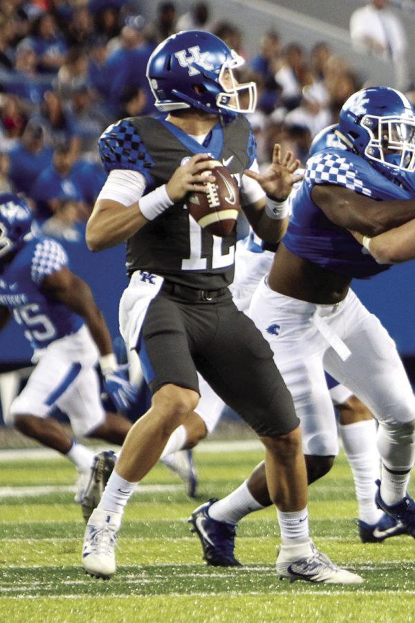 Kentucky Wildcats quarterback Gunnar Hoak drops back to pass during the blue white spring game at Commonwealth Stadium on Friday, April 14, 2017 in Lexington, KY. Photo by Addison Coffey | Staff.