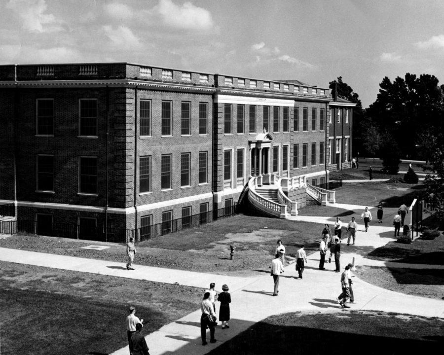 Unidentified students walk past the journalism building in 1951. The Journalism Building was dedicated on November 2, 1951, and named after Enoch Grehan. 