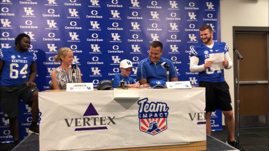 11-year-old Luke Klausing signs his papers to join UKs football team at Kroger Field on August 1, 2018 in Lexington, Ky. Photo by Chris Leach