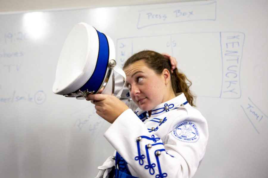 Senior Drum Major Cassie Morrelles puts on her hat before the Kentucky v. Murray State football game on Saturday, Sept. 15, 2018, in Lexington, Kentucky. Morrellesis one of three drum majors and has been a member of the Wildcat Marching Band since she was a freshman at UK. This is her second year as drum major. The friends I’ve made in band over the years are some of the most important friendships I’ve ever made,” said Morrelles. Photo by Arden Barnes | Staff