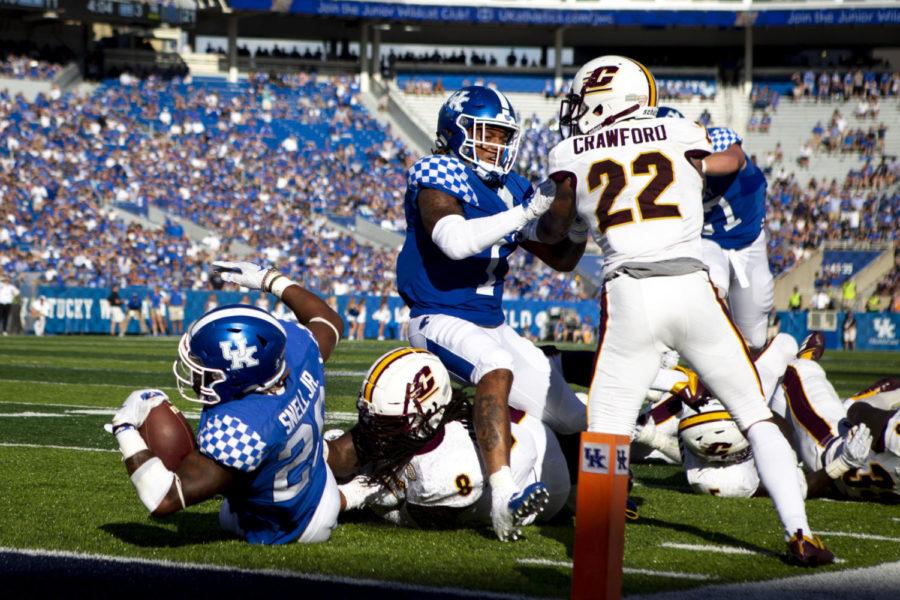 Kentucky Wildcats wide receiver Lynn Bowden Jr. (1) pushes back against Central Michigan as Kentucky Wildcats running back Benny Snell Jr. (26) tumbles into the end zone during the game on Saturday Sept. 1, 2018, at Kroger Field in Lexington, Kentucky. Kentucky won 35-20. Photo by Arden Barnes | Staff