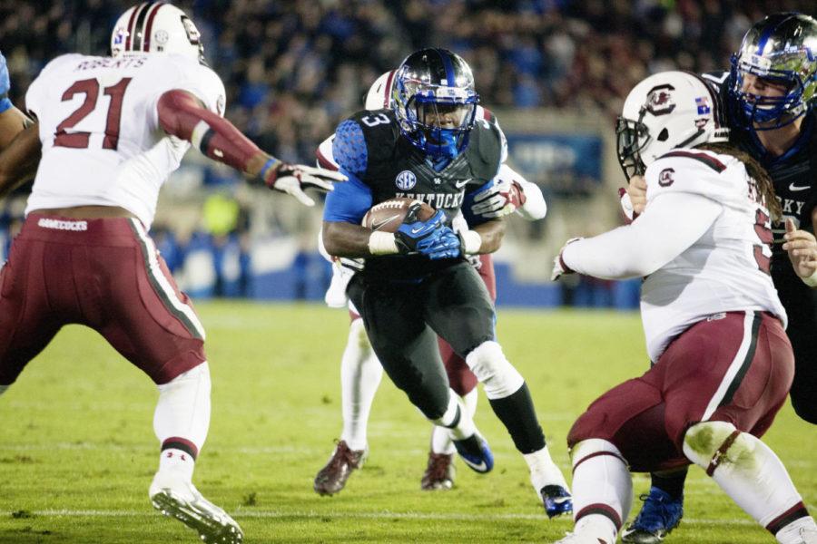 Kentucky Wildcats running back Jojo Kemp runs through the defense during the second half against the South Carolina Gamecocks at Commonwealth Stadium on Saturday, October 4, 2014 in Lexington, Ky. Kentucky upset South Carolina 45-38. Photo by Michael Reaves | Staff