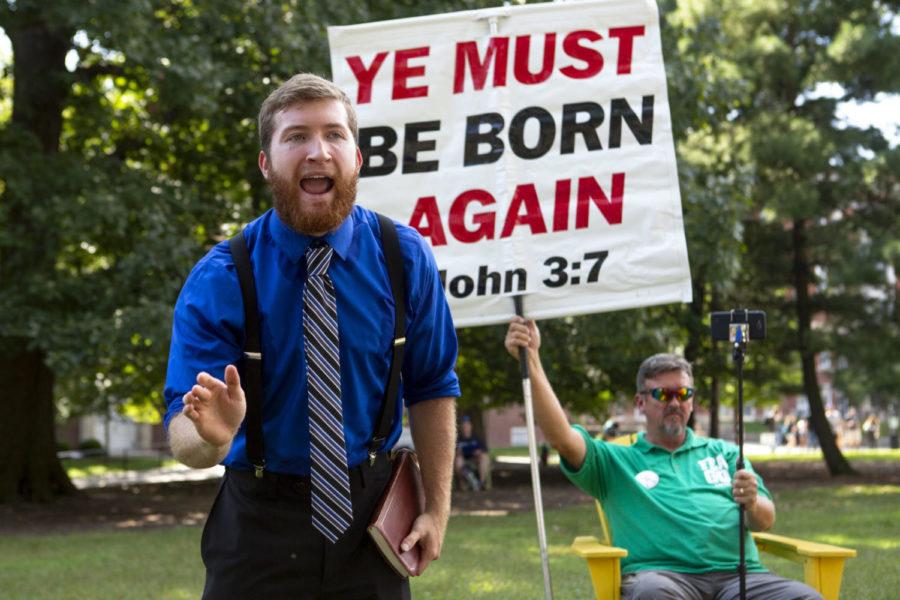 UK students interact with Zachary Humphrey, a preacher from Public Proclaimer Ministries, outside Whitehall on UK's campus on Tuesday, Sept. 8, 2018, in Lexington, Kentucky. Photo by Arden Barnes | Staff