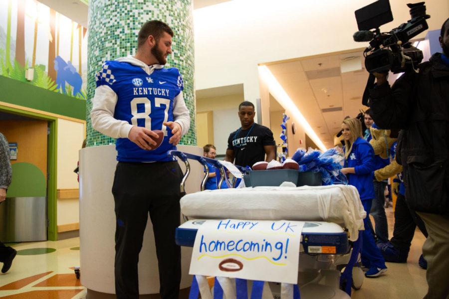 Kentucky football player CJ Conrad accompanied by Scratch and two Kentucky cheerleaders, Josh Marsh and Riley Aguiar, visited Kentucky Childrens Hospital to celebrate homecoming week with the patients on Tuesday Oct. 16, 2018 in Lexington, Ky. Photo by Jordan Prather | Staff