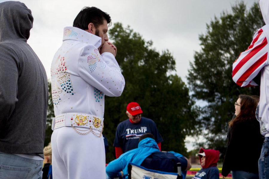 Barry Lockard warms his hands while standing in line, dressed as Elvis Presley, for President Donald Trump's rally on Saturday, Oct. 13, 2018, outside Alumni Coliseum on Eastern Kentucky University's campus in Richmond, Kentucky. Photo by Arden Barnes | Staff
