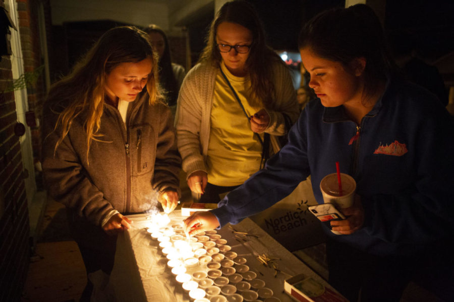 Senior social work majors Katie Marcum (left), Jordan Gennuso and Makayla Lindsey light candles during the vigil held at the Jewish student center on UKs campus in Lexington, Kentucky on Monday, Oct. 29, 2018. The vigil was held in solidarity and remembrance of the victims of the reportedly anti-semitic shooting at a synagogue in Pittsburgh, Pennsylvania, on Saturday. Photo by Arden Barnes | Staff
