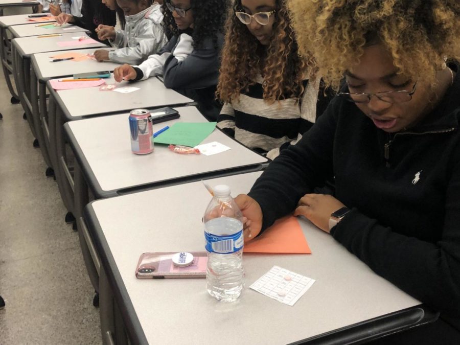 Women attending the All About the Boobs event hosted by the Iota Sigma chapter of Alpha Kappa Alpha participate in a BINGO competition. 
