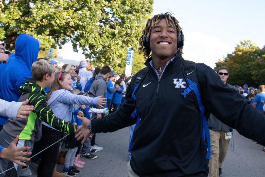 Kentucky Wildcats running back Benny Snell Jr. (26) high fives fans as he walks by. UK football players and coaches greeted fans during Cat Walk before their game against Vanderbilt on Saturday, October 20, 2018 at Kroger Field in Lexington, Kentucky. Photo by Michael Clubb | Staff