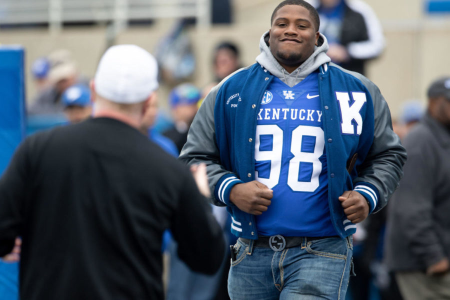 Kentucky Wildcats defensive tackle Tymere Dubose (98) running up to head coach Mark Stoops during the Senior Day ceremony before the game.University of Kentucky football defeated Middle Tennessee State University 34-23 at Kroger Field on Saturday, Nov. 17, 2018 in Lexington, Kentucky. Photo by Michael Clubb | Staff