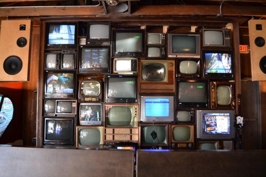 Old television sets cover a wall at the Burl Arcade in Lexington, Kentucky. Photo by Kayleigh Conrad | Staff