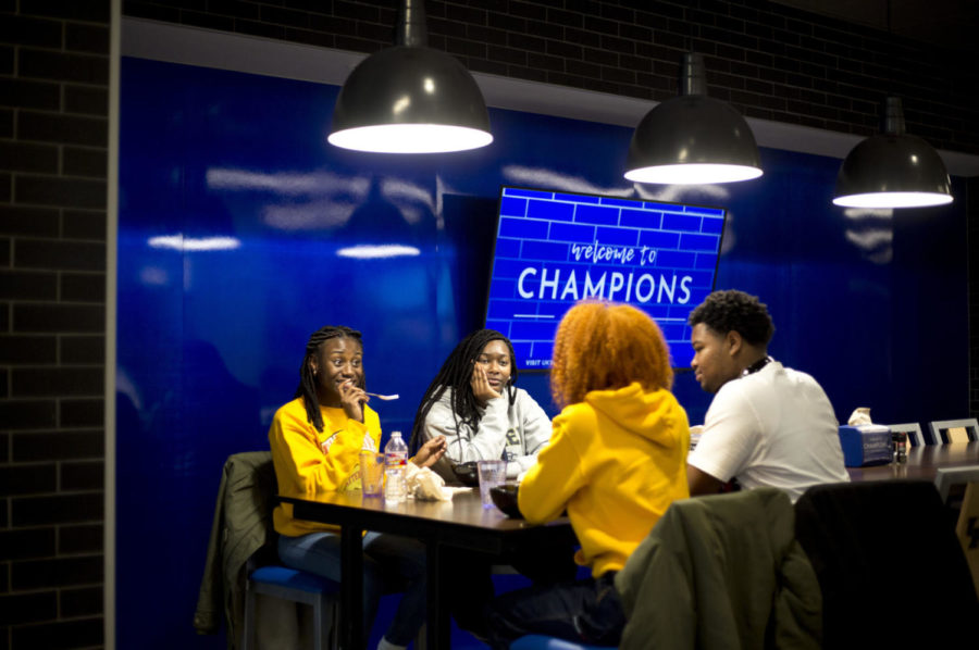 Freshman human nutrition major Haley Jones (left), freshman biology major Madison Brown, freshman communication science disorders major Brandon Walker and freshman biology major CyOntaisha Cunningham eat lunch at the newly opened Champions Kitchen on Tuesday, Jan. 9, 2018. Champions Kitchen is the new dining hall located in the new Student Center on UKs campus in Lexington, Kentucky. Photo by Arden Barnes | Staff