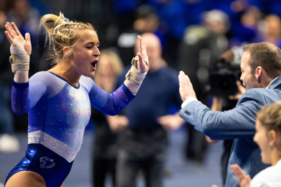 Kentucky gymnast Alex Hyland high-fives head coach Tim Garrison after competing on the vault during the Excite Night meet against Arkansas on Friday, Jan. 18, 2019, at Rupp Arena in Lexington, Kentucky. Kentucky won 195.275 to 193.875.