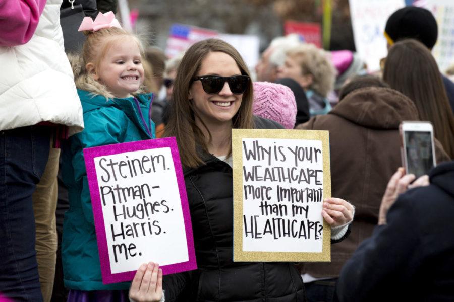 Protestors pose with signs during the NOW Womens March Anniversary Rally in front of the Circuit Courthouse in downtown Lexington, Kentucky on Saturday, January 20, 2018. The rally was an inclusive event held to recognize Lexingtons diverse community and raise awareness for our rights, our safety, our health, and our families said the events Facebook page. Photo by Arden Barnes | Staff