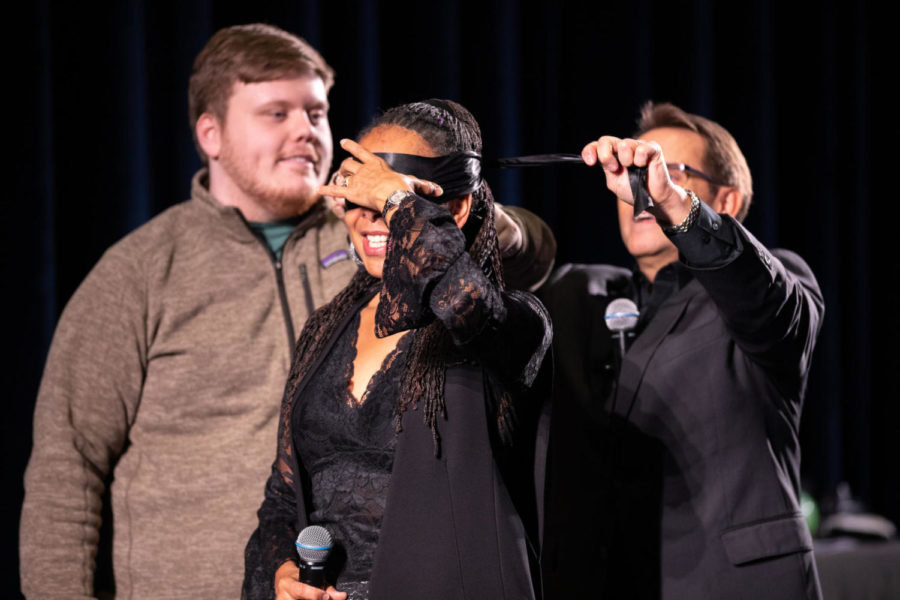 Jeff Evason places a blindfold around Tessa Evason at the Evasons Mentalist Duo show at Worsham Cinema on Monday, Feb. 25, 2019, in Lexington, Kentucky. Photo by Michael Clubb | Staff
