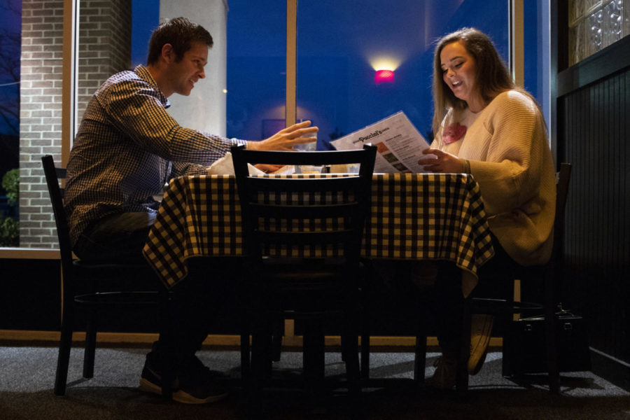 Lauren Zahrn and Collin ODonnell talk while looking at the menu during their blind date on Tuesday, Feb. 5, 2019, at Puccinis in Lexington, Kentucky. Photo by Arden Barnes | Staff