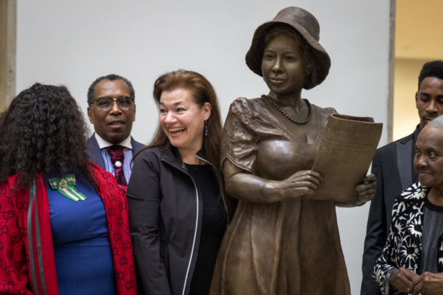 Amanda Matthews poses for a photo next to her statue of Alice Dunnigan, along with Dunnigans family, during a ceremony honoring Dunnigan on Monday, Feb. 4, 2019, at the William T. Young Library in Lexington, Kentucky. Photo by Arden Barnes | Staff