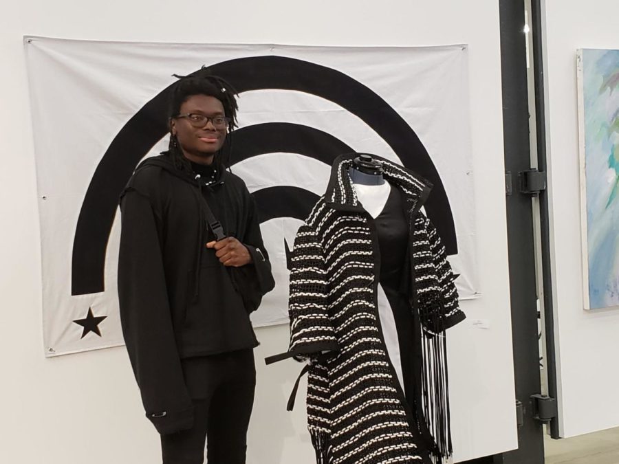 Isaac Couch poses with a coat he made. Couch won the Young Artists' Competition, which was hosted by the Student Activities Board at the SAVS building on March 20, 2019, in Lexington, Kentucky. 